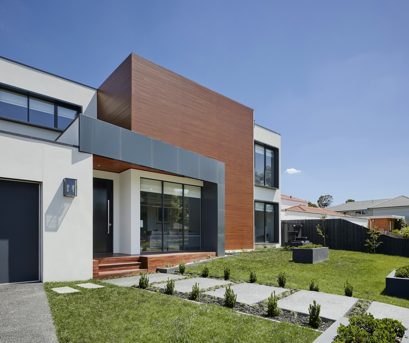 Residential home with open-air terraces and mature landscaping